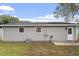 View of backyard featuring a grey exterior, an external door and an air conditioning unit at 1100 Pecan Pl, Durham, NC 27704
