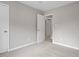 A light-filled bedroom featuring plush carpeting, neutral gray walls, and ample closet space at 1100 Pecan Pl, Durham, NC 27704