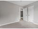 Spacious bedroom featuring neutral carpeting, a doorway, and two closets for ample storage at 1100 Pecan Pl, Durham, NC 27704