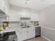 Bright kitchen showcasing white cabinets, marble countertops, stainless steel appliances, and a stylish backsplash at 1100 Pecan Pl, Durham, NC 27704
