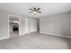 Open living space featuring wood-look floors, neutral walls, and a view into the adjacent kitchen at 1100 Pecan Pl, Durham, NC 27704
