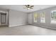 Bright, neutral living room featuring wood-look floors and multiple windows for ample natural light at 1100 Pecan Pl, Durham, NC 27704