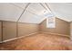 Finished attic space with hardwood floors, natural light, and paneled walls at 1113 Alabama Ave, Durham, NC 27705