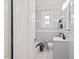 Cozy bathroom featuring tile walls, with a toilet, sink and combination bathtub and shower at 1113 Alabama Ave, Durham, NC 27705