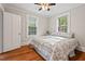 Cozy bedroom with hardwood floors, natural light, and a comfortable queen-sized bed at 1113 Alabama Ave, Durham, NC 27705