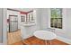 Charming breakfast nook featuring hardwood floors, large windows, and a peek into the kitchen at 1113 Alabama Ave, Durham, NC 27705
