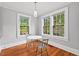 Cozy dining area featuring hardwood floors, natural light, and a table with seating for two at 1113 Alabama Ave, Durham, NC 27705