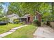Charming brick home with a screened-in porch and lush landscaping at 1113 Alabama Ave, Durham, NC 27705