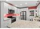 Bright kitchen with stainless steel appliances, granite countertops, and white cabinetry at 1113 Alabama Ave, Durham, NC 27705