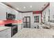 Updated kitchen featuring granite countertops, stainless steel appliances, and white cabinetry at 1113 Alabama Ave, Durham, NC 27705