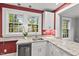 This kitchen features granite countertops, stainless steel dishwasher and a view to the outdoors at 1113 Alabama Ave, Durham, NC 27705