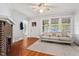 Sunlit living room featuring hardwood floors, a brick fireplace, and a comfortable sofa at 1113 Alabama Ave, Durham, NC 27705