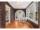 Sunlit office space with brick walls, hardwood floors, and large windows at 1113 Alabama Ave, Durham, NC 27705