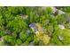 Aerial view showcasing a home surrounded by lush greenery in a wooded neighborhood at 112 Meadowbrook Dr, Chapel Hill, NC 27514