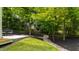 Backyard featuring fresh mulch, landscaping, a small creek, and a glimpse of the home at 112 Meadowbrook Dr, Chapel Hill, NC 27514