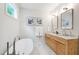 Bright bathroom features double sink vanity and freestanding tub with picture frame view at 112 Meadowbrook Dr, Chapel Hill, NC 27514