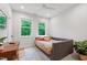 Serene bedroom with large windows, a daybed, and a stylish desk area at 112 Meadowbrook Dr, Chapel Hill, NC 27514