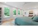 Spacious bedroom filled with natural light boasts ample windows and a calming color palette at 112 Meadowbrook Dr, Chapel Hill, NC 27514