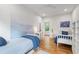 Inviting bedroom with twin beds, hardwood floors, and a serene mural wall at 112 Meadowbrook Dr, Chapel Hill, NC 27514