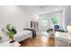 Charming bedroom with two twin beds, bright windows, and hardwood floors at 112 Meadowbrook Dr, Chapel Hill, NC 27514