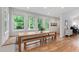 Dining area featuring hardwood floors, built in seating, and bright lighting at 112 Meadowbrook Dr, Chapel Hill, NC 27514