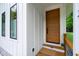 Stylish front door with wood finish, complemented by modern windows and exterior design at 112 Meadowbrook Dr, Chapel Hill, NC 27514