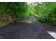 Backyard garden with a wooden raised garden bed and freshly laid dark mulch at 112 Meadowbrook Dr, Chapel Hill, NC 27514