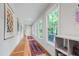 Hallway featuring built-in storage, vibrant rugs, and natural light from large windows at 112 Meadowbrook Dr, Chapel Hill, NC 27514