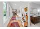 Hallway with hardwood floors leading to a bathroom; features built-in storage at 112 Meadowbrook Dr, Chapel Hill, NC 27514