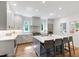Well-lit kitchen with gray cabinets, stainless steel appliances, and a patterned tile backsplash at 112 Meadowbrook Dr, Chapel Hill, NC 27514