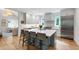 Modern kitchen featuring gray cabinetry, a center island with seating, and a stainless steel refrigerator at 112 Meadowbrook Dr, Chapel Hill, NC 27514