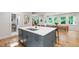 Kitchen island with a stainless steel sink and faucet, gray cabinetry, and an adjacent dining area at 112 Meadowbrook Dr, Chapel Hill, NC 27514
