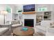 Cozy living room featuring a fireplace, built-in bookshelves, and comfortable armchairs for relaxation at 112 Meadowbrook Dr, Chapel Hill, NC 27514