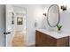 Stylist powder room features wood vanity and stylish fixtures at 112 Meadowbrook Dr, Chapel Hill, NC 27514