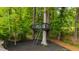 Treehouse nestled among trees with ladder, dark mulch, and surrounding nature at 112 Meadowbrook Dr, Chapel Hill, NC 27514
