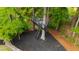 Elevated treehouse with ladder, platform, and metal railings, nestled within the lush greenery at 112 Meadowbrook Dr, Chapel Hill, NC 27514
