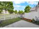Cozy backyard with a white picket fence and a small patio, perfect for relaxation and outdoor enjoyment at 1204 Maroon Dr, Durham, NC 27713
