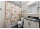 Cozy bathroom featuring a floral shower curtain and a vanity sink at 1204 Maroon Dr, Durham, NC 27713