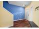 Bright entryway with hardwood floors, a vibrant accent wall, and a convenient coat rack at 1204 Maroon Dr, Durham, NC 27713