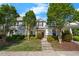Charming townhouse with a manicured lawn and mature trees, offering curb appeal at 1204 Maroon Dr, Durham, NC 27713