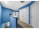Upstairs hallway featuring a blue accent wall and neutral carpet at 1204 Maroon Dr, Durham, NC 27713