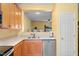 Well-lit kitchen featuring stainless steel appliances and a convenient pass-through window at 1204 Maroon Dr, Durham, NC 27713