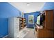 Home office with bright blue walls and built in shelving at 1204 Maroon Dr, Durham, NC 27713