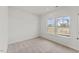 Cozy bedroom with plush carpeting and large windows offering neighborhood views at 121 Cribbs Ln, Middlesex, NC 27557
