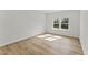 Sunlit bedroom with wood-look floors and double windows at 121 Cribbs Ln, Middlesex, NC 27557