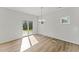 Bright dining room with hardwood floors, chandelier, and glass sliding door at 121 Cribbs Ln, Middlesex, NC 27557