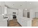 Bright kitchen with white cabinets, stainless steel appliances, and hardwood floors at 121 Cribbs Ln, Middlesex, NC 27557