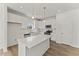 Bright kitchen features white cabinets, stainless steel appliances, and center island with pendant lighting at 121 Cribbs Ln, Middlesex, NC 27557