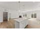 Open-concept living area with island, fireplace, and sliding glass doors to the backyard at 121 Cribbs Ln, Middlesex, NC 27557
