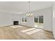 Bright living room with fireplace, hardwood floors, chandelier, and glass sliding door at 121 Cribbs Ln, Middlesex, NC 27557